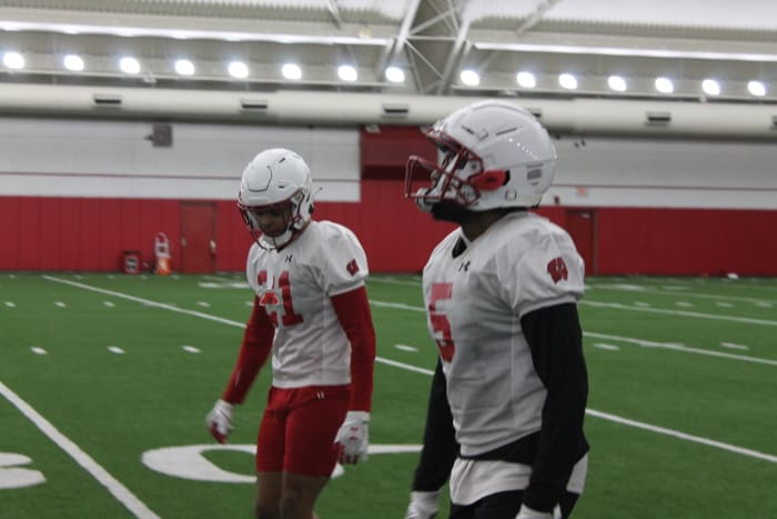 Cedrick Dort (No. 5) and Avyonne Jones (No. 21) hustle back after a special team's drill.